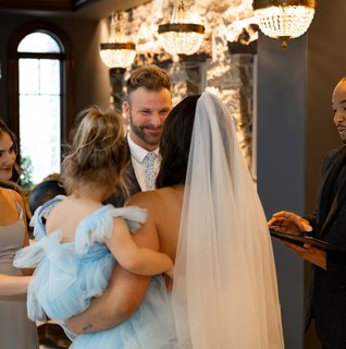Bride and groom exchange vows during an intimate wedding ceremony at The Willows at Ashcombe in Pennsylvania with The Brofficiant officiating while their daughters stand beside them.