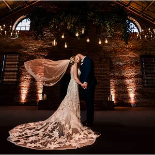 wedding bride kissing in a gourgeous indoor venue